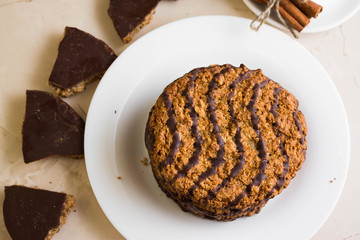 Oatmeal cookies with chocolate on a white plate. Tasty dessert.