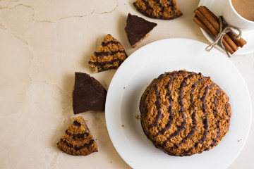 Oatmeal cookies with chocolate on a white plate. Tasty dessert.