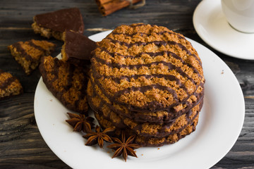 Oatmeal cookies with chocolate on a white plate. Tasty dessert.