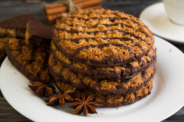 Oatmeal cookies with chocolate on a white plate. Tasty dessert.