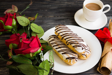 Eclairs in white glaze on a white plate. Delicious dessert.