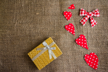 Hearts of fabric on sackcloth. Bright greeting card.