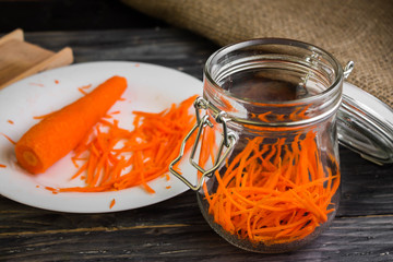 Grated carrot on a wooden background in rustic style