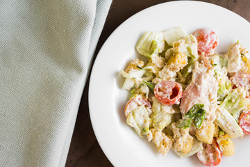 Caesar salad with chicken on a marble table