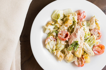 Caesar salad with chicken on a marble table