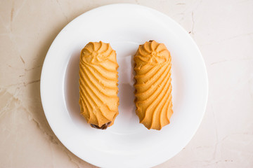 Biscuit sandwich with caramelized milk on a marble table. Tasty dessert.