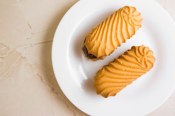Biscuit sandwich with caramelized milk on a marble table. Tasty dessert.