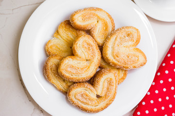 Berliner Cookies in a white plate on a marble table. Tasty dessert.