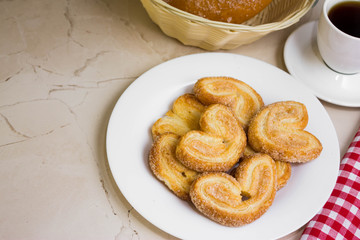 Berliner Cookies in a white plate on a marble table. Tasty dessert.