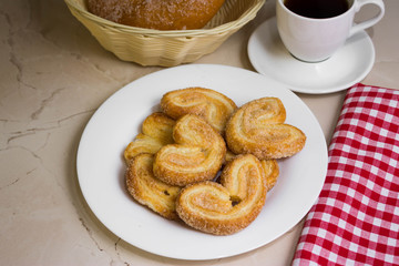 Berliner Cookies in a white plate on a marble table. Tasty dessert.