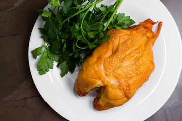 Smoked chicken breast on a marble table and ingredients. A delicious dish.