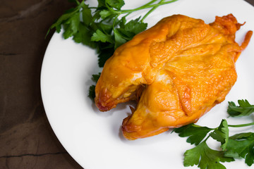 Smoked chicken breast on a marble table and ingredients. A delicious dish.