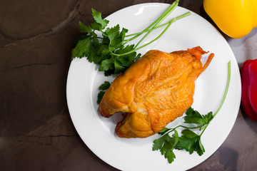 Smoked chicken breast on a marble table and ingredients. A delicious dish.