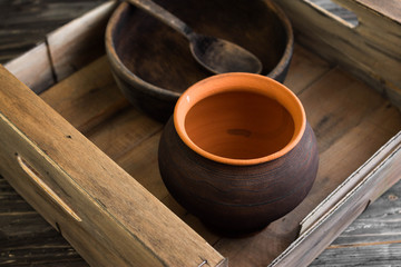 Rustic crockery in a box on a wooden table in rustic style