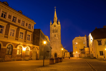 Naklejka na ściany i meble Medieval church of Saint John and night old town view of Cesis, Latvia.