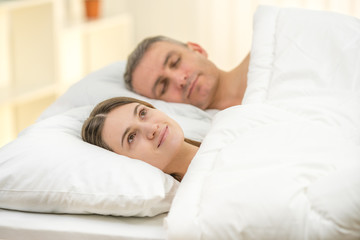 Obraz na płótnie Canvas The beautiful couple lay on the bed