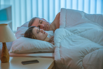 The depressed woman lay near the man