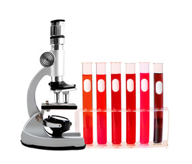 Medical test tubes with blood in holder and microscope on white background
