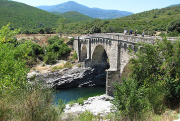 Fototapeta na wymiar The Genoese bridge with three arches on the Tavignano river, near Altiani, Corsica