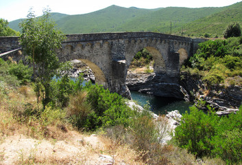 Fototapeta na wymiar The Genoese bridge with three arches on the Tavignano river, near Altiani, Corsica