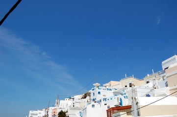 Piece of Mediterranean cruise On Santorini island, Greece. The view from the hotel on the lower terrace and the shore of the Aegean sea. characteristic architecture blue and white tones in the decor
