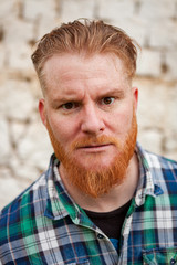 Fototapeta premium Portrait of red haired man expressing a emotion