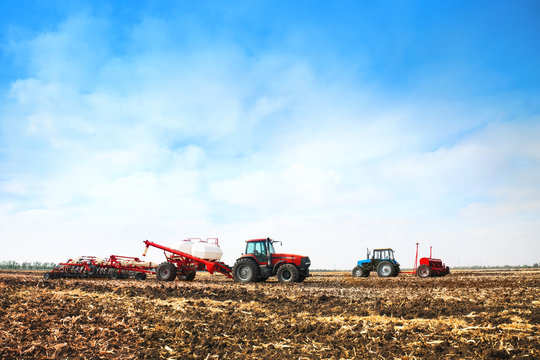 Tractors with tanks in the field. Agricultural machinery and farming.
