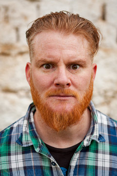 Portrait of red haired man expressing a emotion