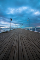 Wooden pier in Gdynia Orlowo in the morning with colors of sunrise. Poland. Europe.