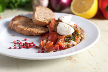 Italian appetizer of eggplant with mozzarella cheese. On vegetables background