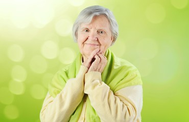 Senior happy woman on green background.