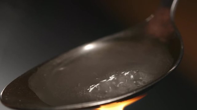 CLOSE UP: Heating a heroin in the spoon