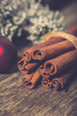 Cinnamon stick on old vintage wooden table. Christmas spices background