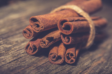 Cinnamon stick on old vintage wooden table. Christmas spices background