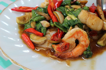 Close-up of a spicy asian shrimp and vegetables meal served on a plate. Thai name for this everyday cuisine is pad krapow goong / talay © Hi-Point