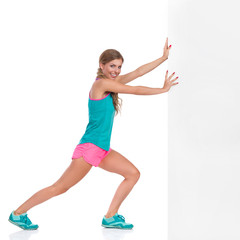 Woman In Sports Clothes Pushing Surrounding Wall