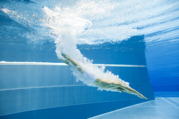 Underwater View Of A Man Jumping Into The Water