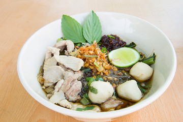 Spicy TOM YAM pork noodle soup with lemongrass, chilly pasted and lime juice.