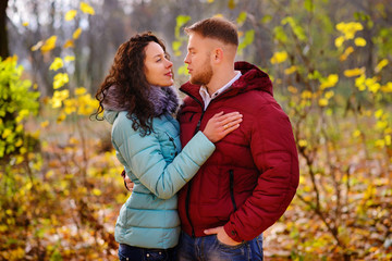 Lovers walking hand in hand in autumn park