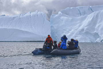 Zodiac tour near enourmous iceberg in the arctic