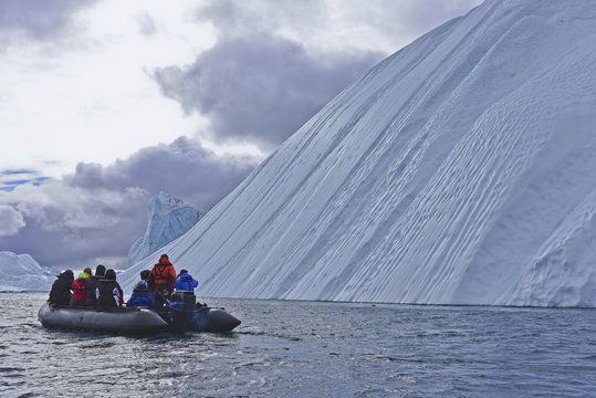 Zodiac tour near enourmous iceberg in the arctic