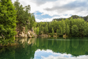 Fototapeta na wymiar Green lake in the rock city in the Czech republic.