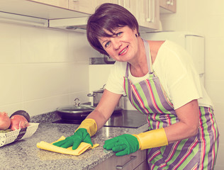 retiree woman cleaning home