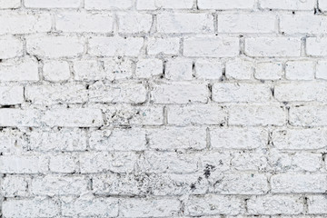 Old white concrete wall with cracks