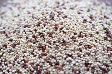 Quinoa - unusual cereal health is scattered on a wooden brown board