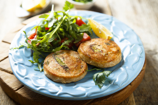 Salmon cakes with vegetables and arugula salad