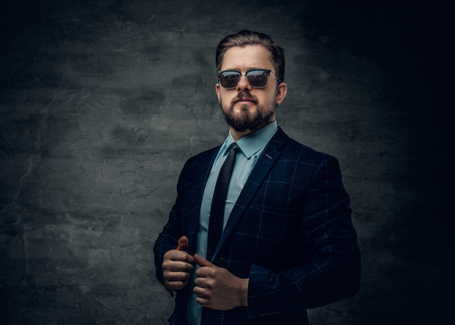 A Man Dressed In A Jacket, Bow Tie And Sunglasses.