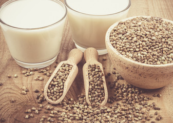 Hemp milk, seeds on wooden background . Close Up .
