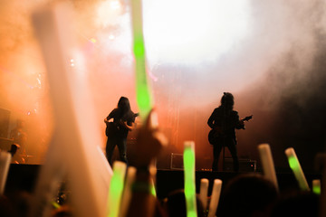 Fototapeta premium Blurred background concert : Bokeh lighting in concert with audience, Music showbiz concept, music performance concert with bokeh spotlight. entertainment concert lighting on stage, blur disco party