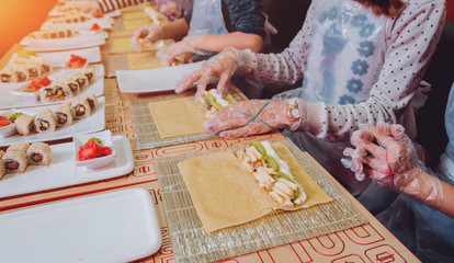Children prepare sushi and rolls
